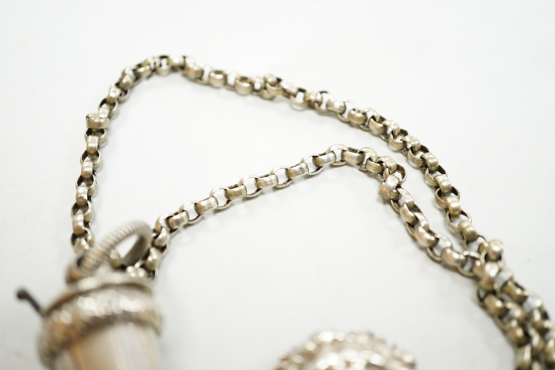 A Victorian silver whistle and case by George Unite, Birmingham, 1860, 93mm, suspended from a white metal chain with lion mask mount.